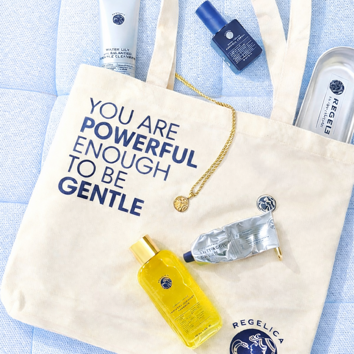 Tote bag with motivational quote and beauty products on a light blue background